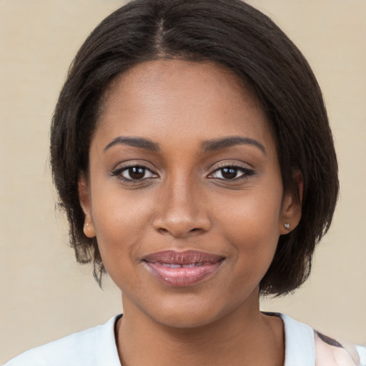 Joyful black young-adult female with medium  brown hair and brown eyes