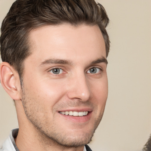 Joyful white young-adult male with short  brown hair and brown eyes