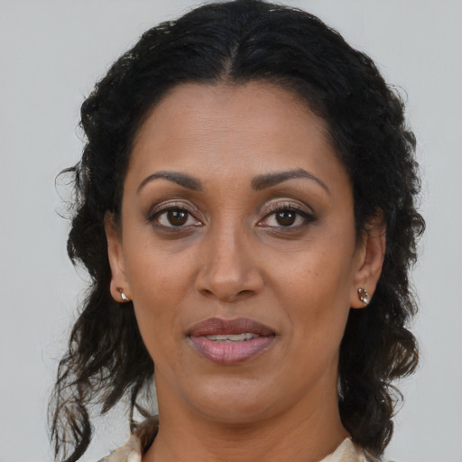 Joyful black adult female with medium  brown hair and brown eyes