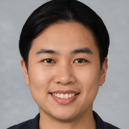 Joyful asian young-adult male with short  black hair and brown eyes