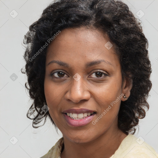 Joyful black young-adult female with long  brown hair and brown eyes