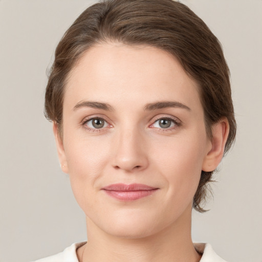 Joyful white young-adult female with short  brown hair and grey eyes