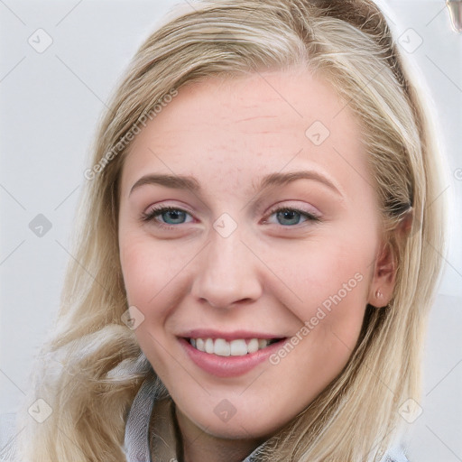 Joyful white young-adult female with long  brown hair and blue eyes