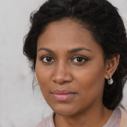 Joyful black young-adult female with medium  brown hair and brown eyes