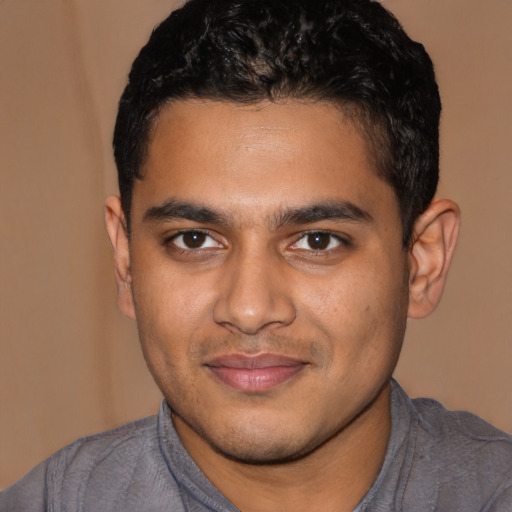 Joyful latino young-adult male with short  black hair and brown eyes