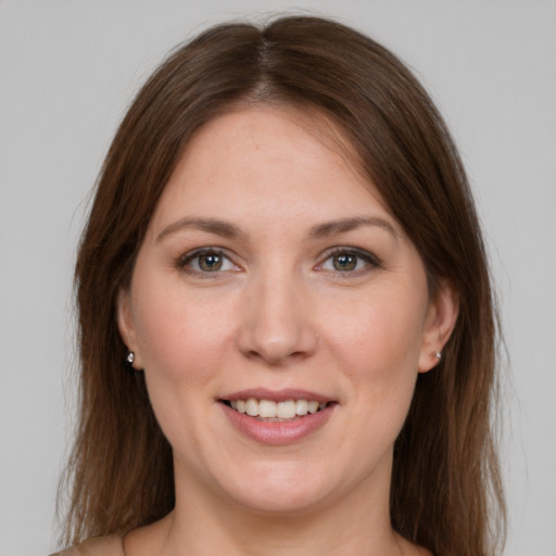 Joyful white young-adult female with long  brown hair and grey eyes