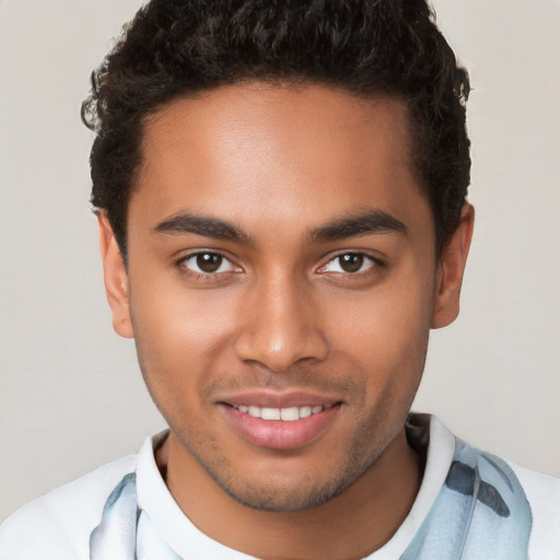 Joyful latino young-adult male with short  brown hair and brown eyes