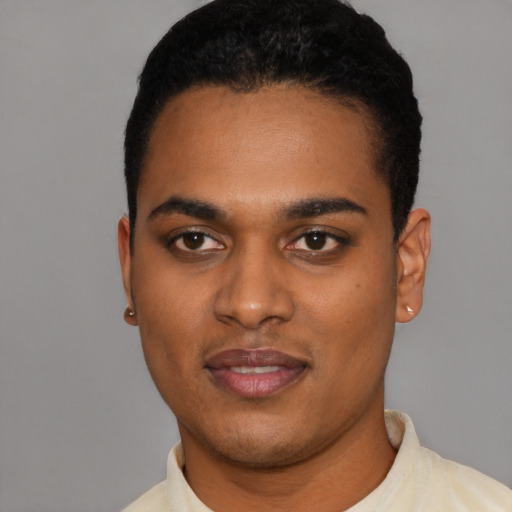 Joyful latino young-adult male with short  black hair and brown eyes