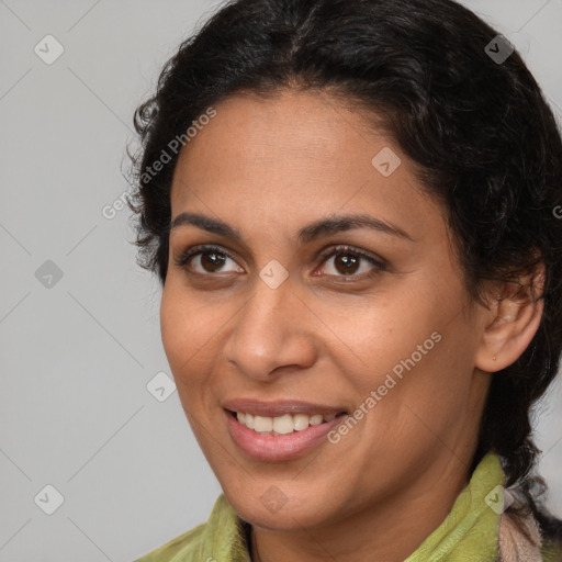 Joyful latino young-adult female with long  brown hair and brown eyes