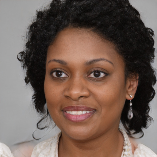 Joyful black young-adult female with medium  black hair and brown eyes