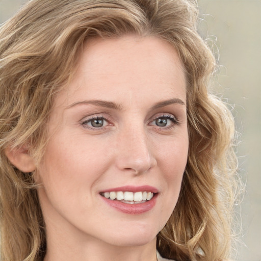 Joyful white young-adult female with long  brown hair and blue eyes