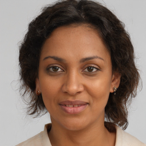 Joyful black young-adult female with medium  brown hair and brown eyes