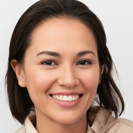 Joyful white young-adult female with medium  brown hair and brown eyes