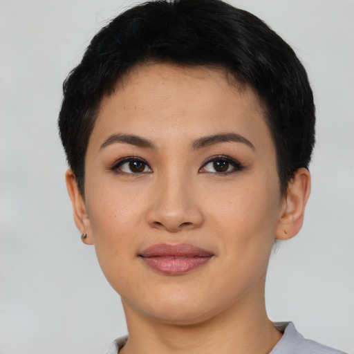 Joyful asian young-adult female with short  brown hair and brown eyes