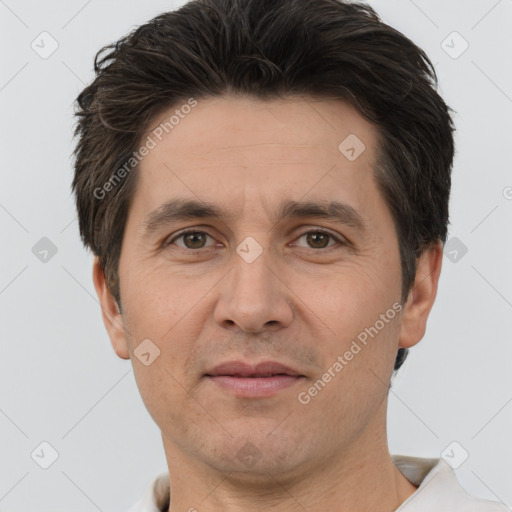 Joyful white adult male with short  brown hair and brown eyes