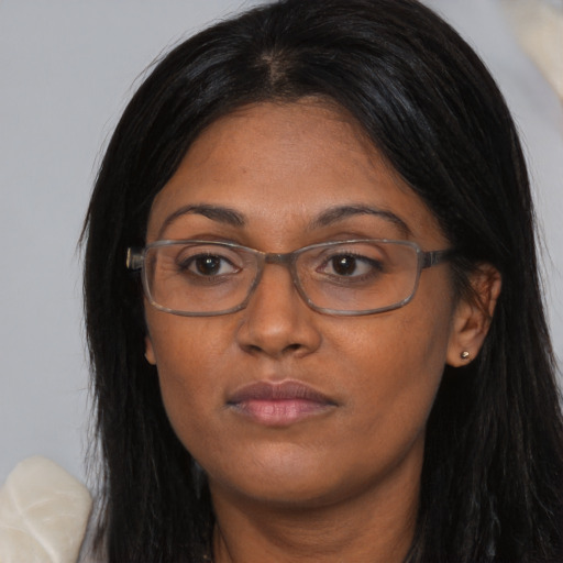 Neutral asian adult female with long  brown hair and brown eyes