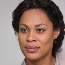 Joyful black young-adult female with medium  brown hair and brown eyes