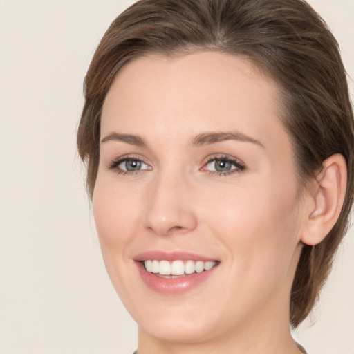 Joyful white young-adult female with medium  brown hair and brown eyes