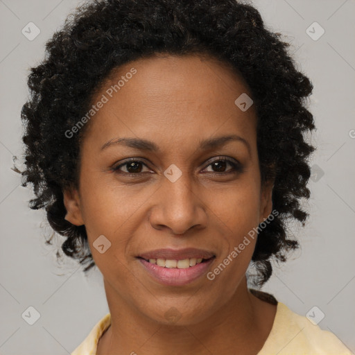 Joyful black adult female with short  brown hair and brown eyes