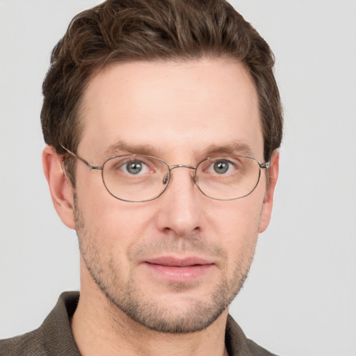 Joyful white adult male with short  brown hair and grey eyes