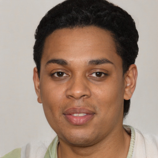 Joyful black young-adult male with short  black hair and brown eyes