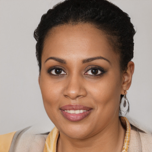 Joyful black young-adult female with short  brown hair and brown eyes