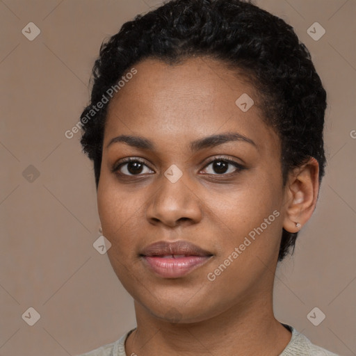 Joyful black young-adult female with short  black hair and brown eyes