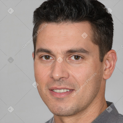 Joyful white adult male with short  brown hair and brown eyes