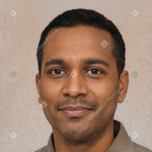 Joyful latino adult male with short  black hair and brown eyes