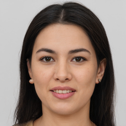 Joyful latino young-adult female with long  brown hair and brown eyes