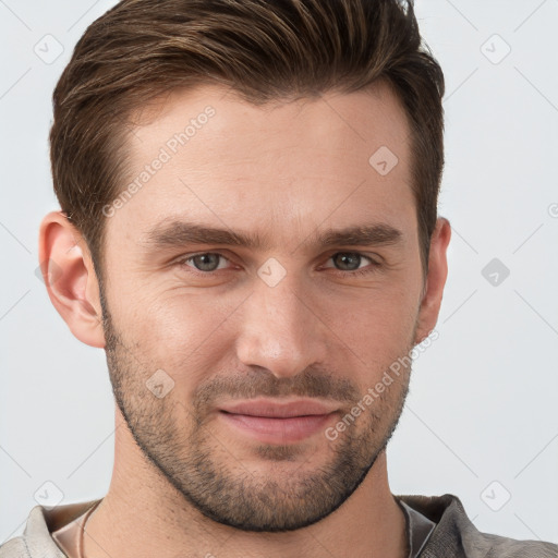 Joyful white young-adult male with short  brown hair and grey eyes