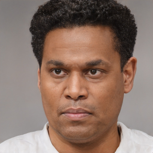 Neutral latino adult male with short  black hair and brown eyes