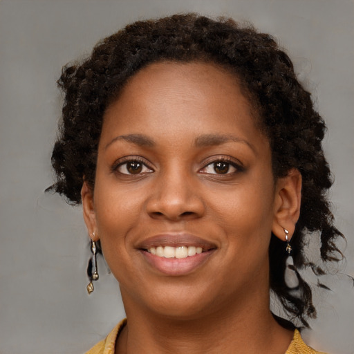 Joyful black young-adult female with medium  brown hair and brown eyes