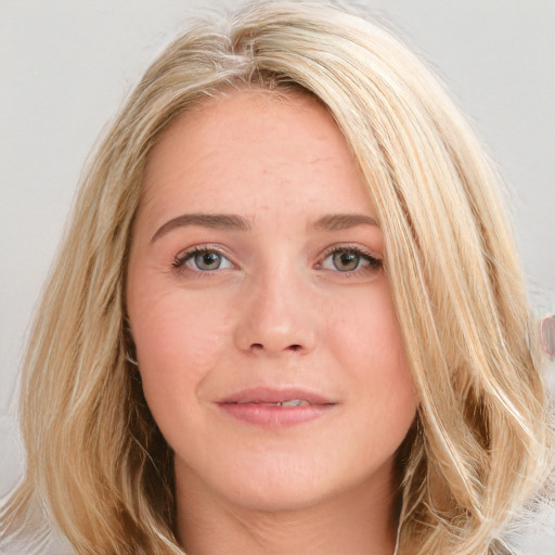 Joyful white young-adult female with long  brown hair and blue eyes