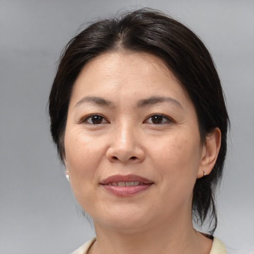 Joyful white adult female with medium  brown hair and brown eyes