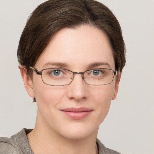 Joyful white young-adult female with short  brown hair and grey eyes