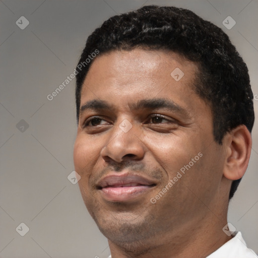 Joyful latino adult male with short  black hair and brown eyes