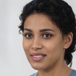 Joyful latino young-adult female with short  black hair and brown eyes