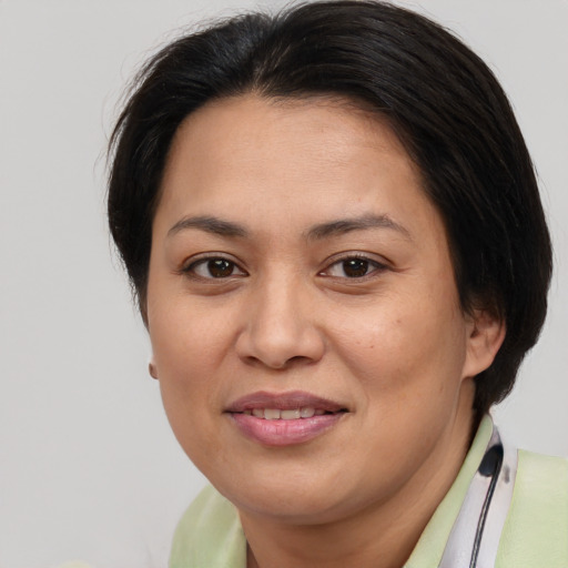 Joyful asian adult female with medium  brown hair and brown eyes