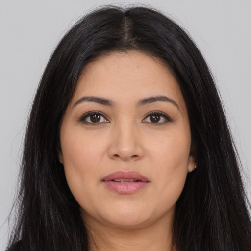 Joyful asian young-adult female with long  black hair and brown eyes