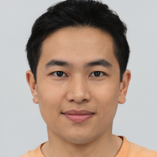Joyful asian young-adult male with short  black hair and brown eyes
