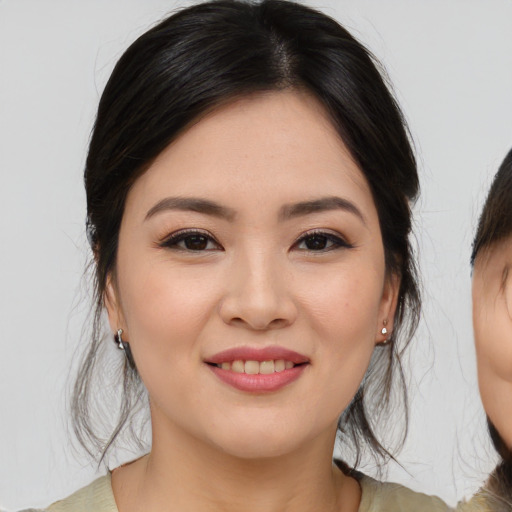 Joyful asian young-adult female with medium  brown hair and brown eyes
