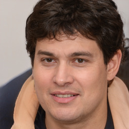 Joyful white adult male with medium  brown hair and brown eyes