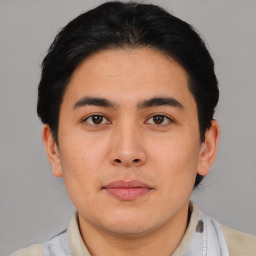 Joyful asian young-adult male with short  brown hair and brown eyes