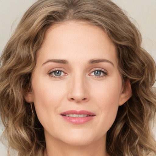 Joyful white young-adult female with long  brown hair and green eyes