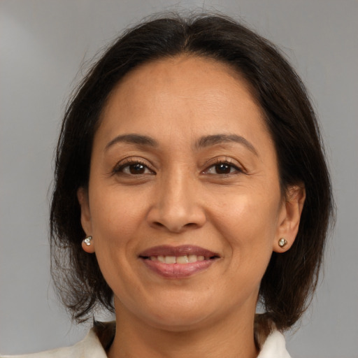 Joyful white adult female with medium  brown hair and brown eyes