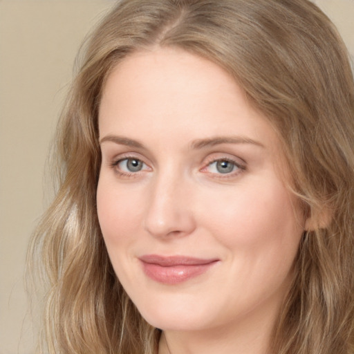 Joyful white young-adult female with long  brown hair and blue eyes