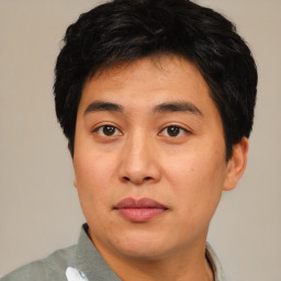 Joyful asian young-adult male with short  brown hair and brown eyes