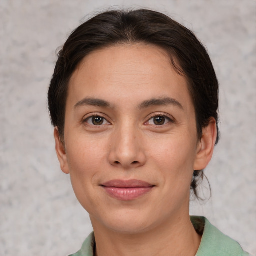 Joyful white adult female with short  brown hair and brown eyes