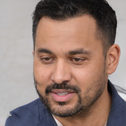 Joyful white adult male with short  black hair and brown eyes